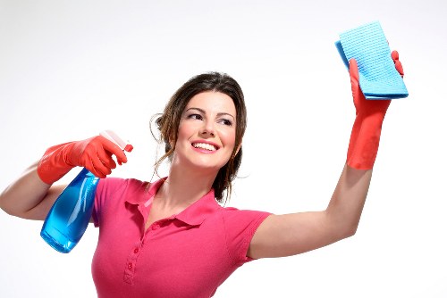 Technician performing upholstery cleaning on a fabric chair